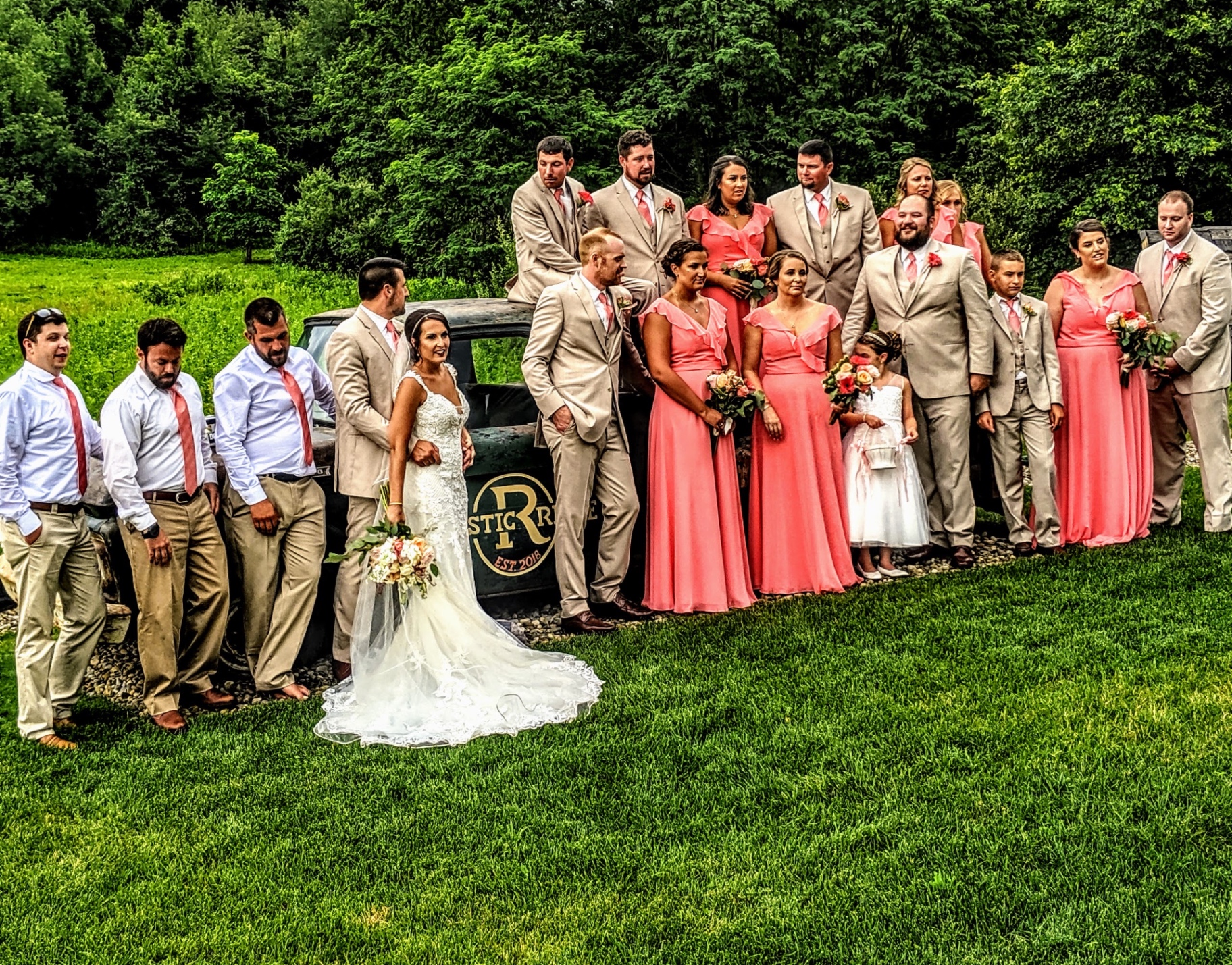 Bridal party at the vintage truck Large bridal party in coral and tan posing around the vintage Rustic Ridge pickup truck on the lawn